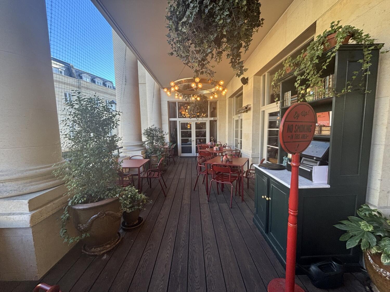 From door facing right. Staff counter on right. Tables and chairs along left and right.