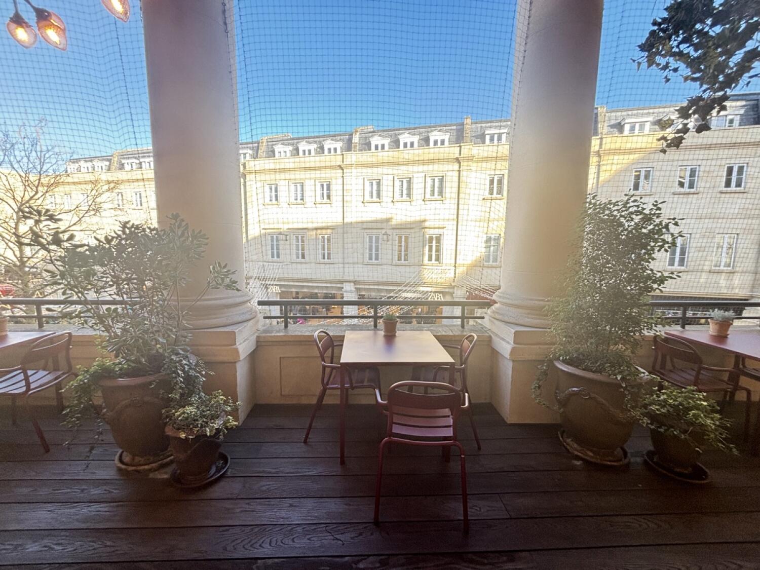 From door facing straight. Tables and chairs ahead.