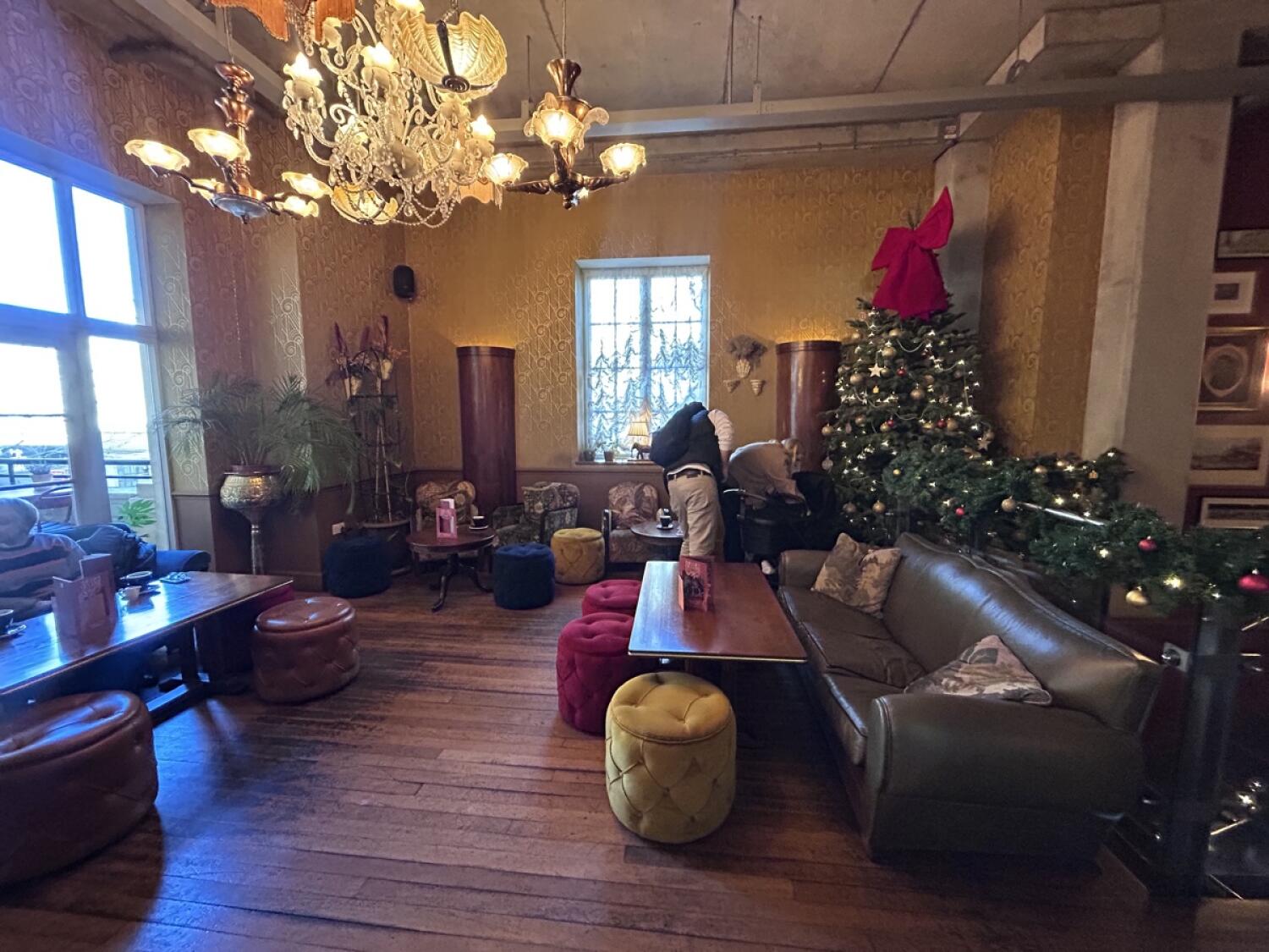 From entrance facing right. Couches and stools on left and right. Armchairs and stools at back.