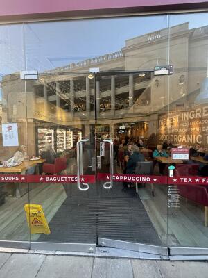 Glass doors ahead. Push handles in centre to open.