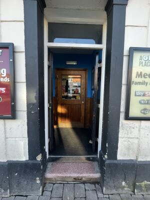Black wooden double door. Push from center to open.