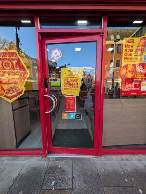 Red metal-framed glass door. Pull from handle on left to open.