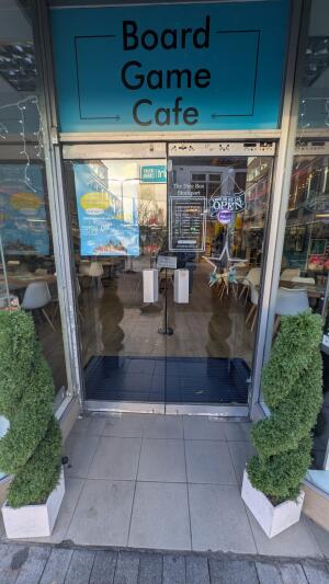 Glass doors. Pull from metal handles at centre to open.