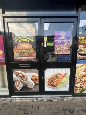 Black metal-framed glass doors. Pull from handle at centre to open.