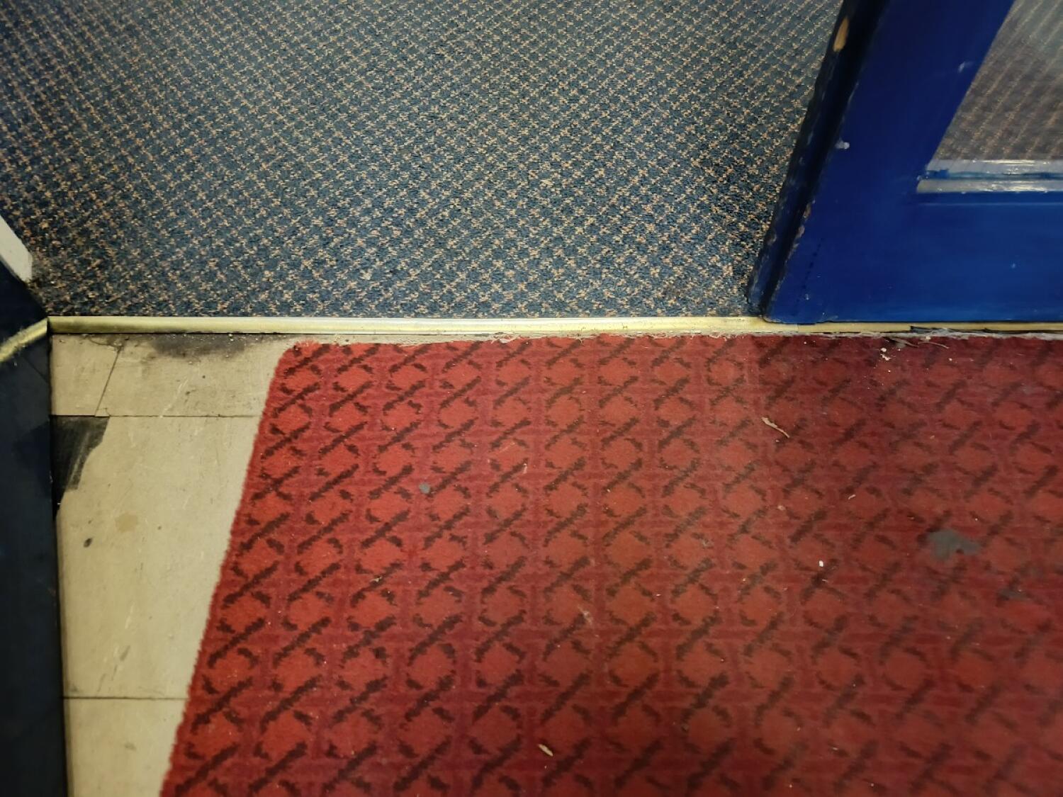 Small metal bump at foot of entrance. Doormat before and after.