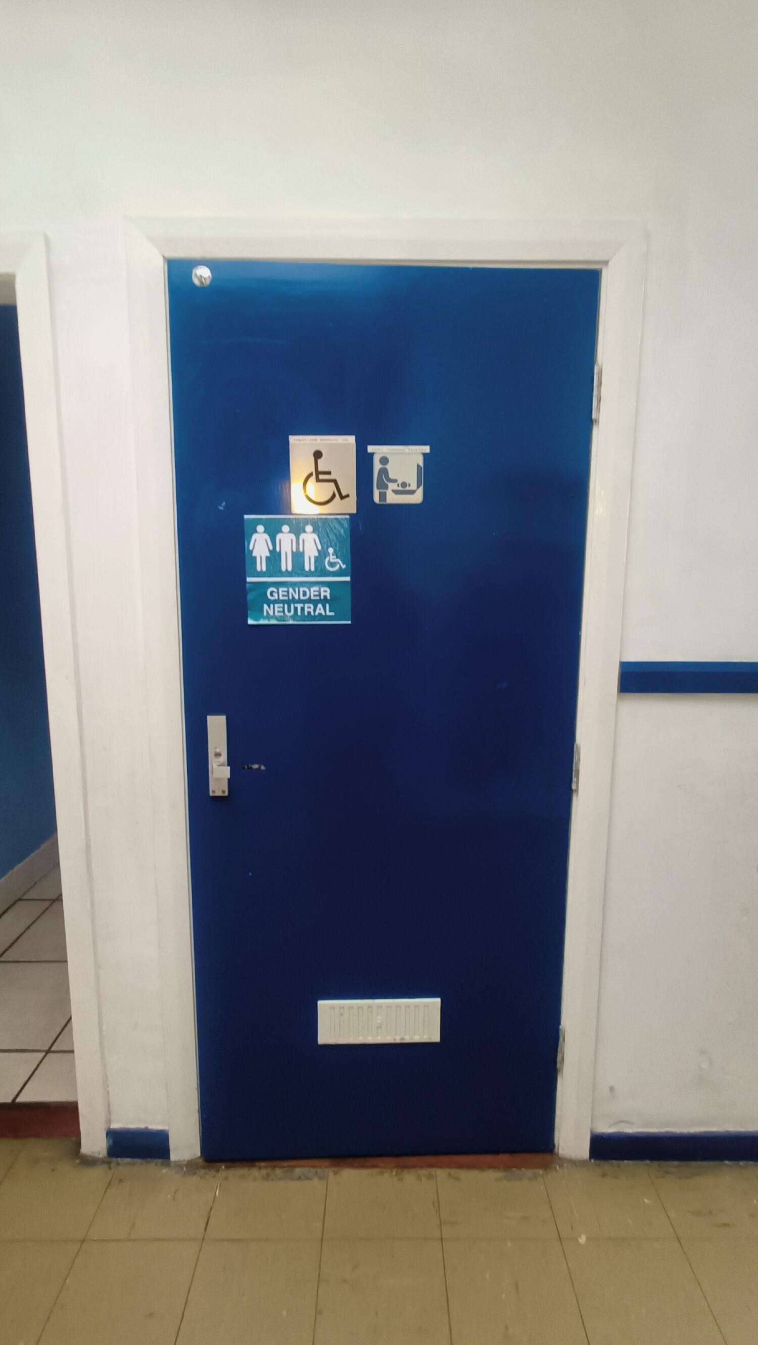 From end of path facing straight. Blue toilet door ahead. Pull handle on left to open.
