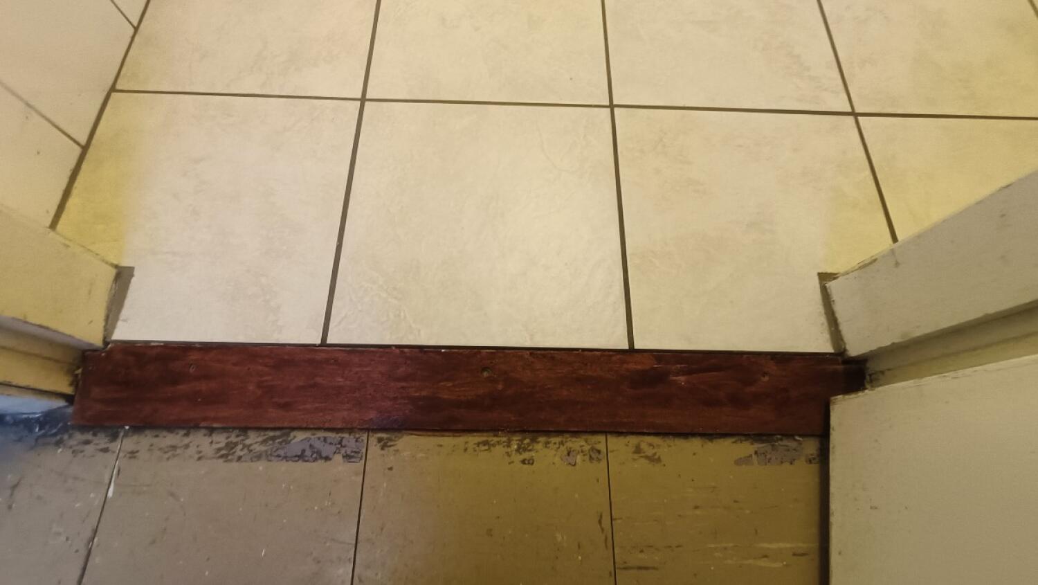 Small wooden bump at foot of door.