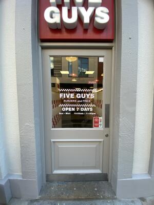 Grey door with glass panelling. Push from right to open.