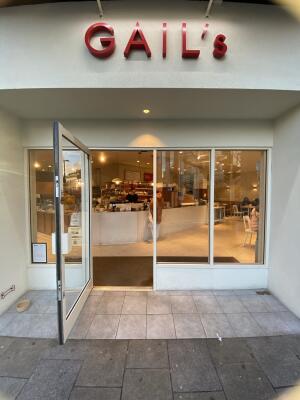 White framed glass door. Pull white metal handle from right to open.
