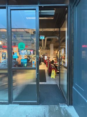 Black framed glass doors ahead. Push from centre to open.