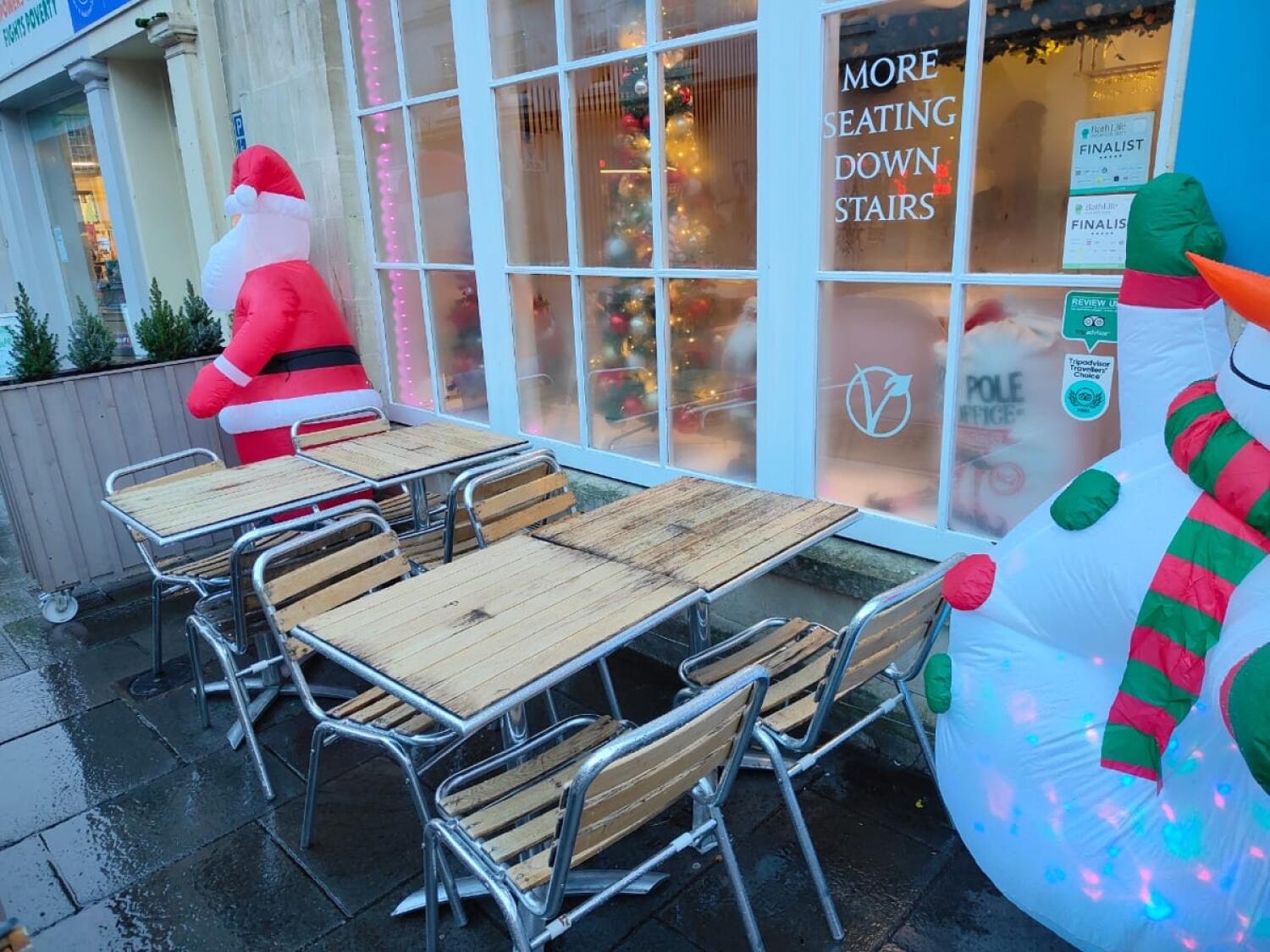 From opening facing right. Tables and chairs at back. Inflatable decorations at back left and right.
