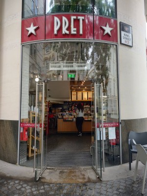 Glass doors with silver handles in middle, push to open.