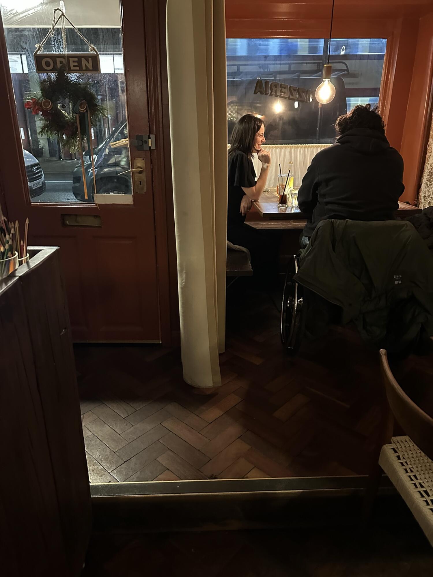 One step down after door.  
Table with chairs in centre by window.  