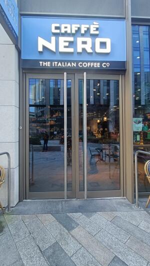 Dark framed glass door to venue. Pull handle in centre to open.