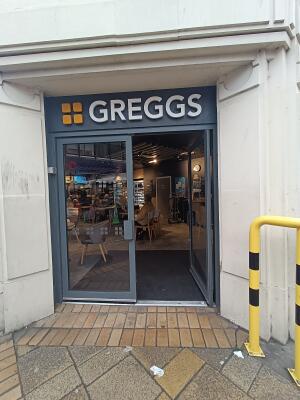 Grey metal-framed glass door. Push from handles in middle to open.