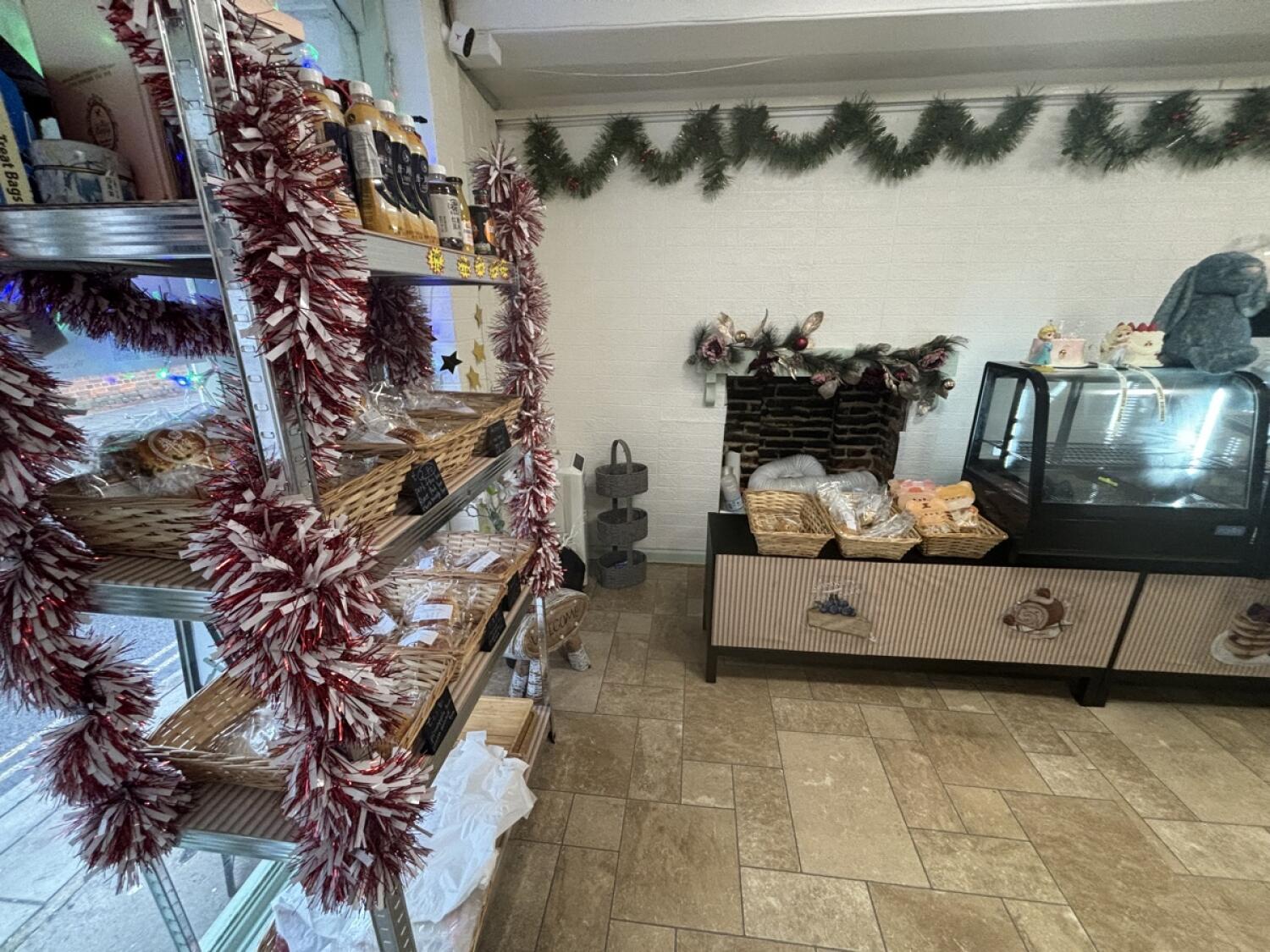 From entrance facing left. Food display shelf on left and along back wall.