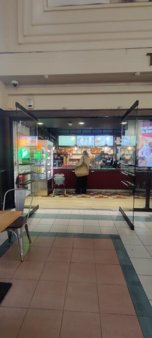 Glass door ahead. Multifunctional grab rails and  handles along center of each door.