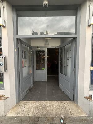 Grey framed glass doors ahead. Push from centre to open.