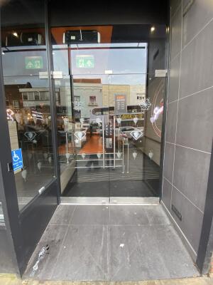 Glass doors. Pull silver metal handle from centre to open.