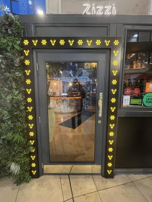 Black metal-framed glass door. Pull from handle on right to open.
