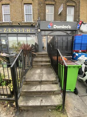 Seven steps up to entrance door. Black handrails on both sides.