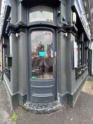 Grey framed glass door ahead. Push from right to open.