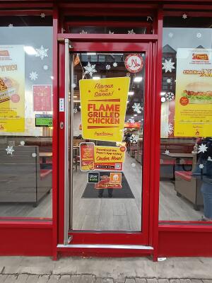 Red metal-framed glass door. Push from handle on left to open.