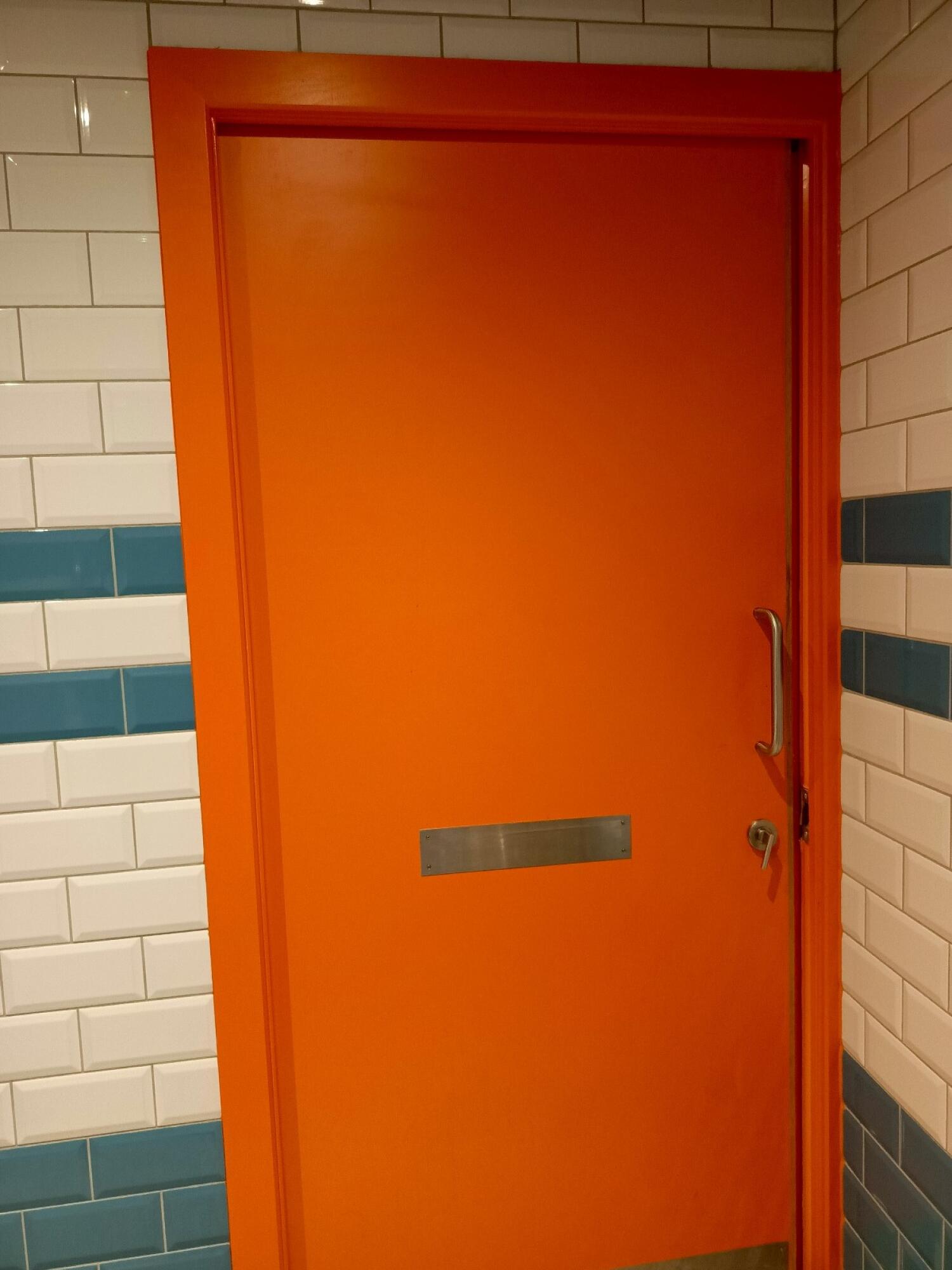 From back of door. Pull door from handle on right towards left to open.