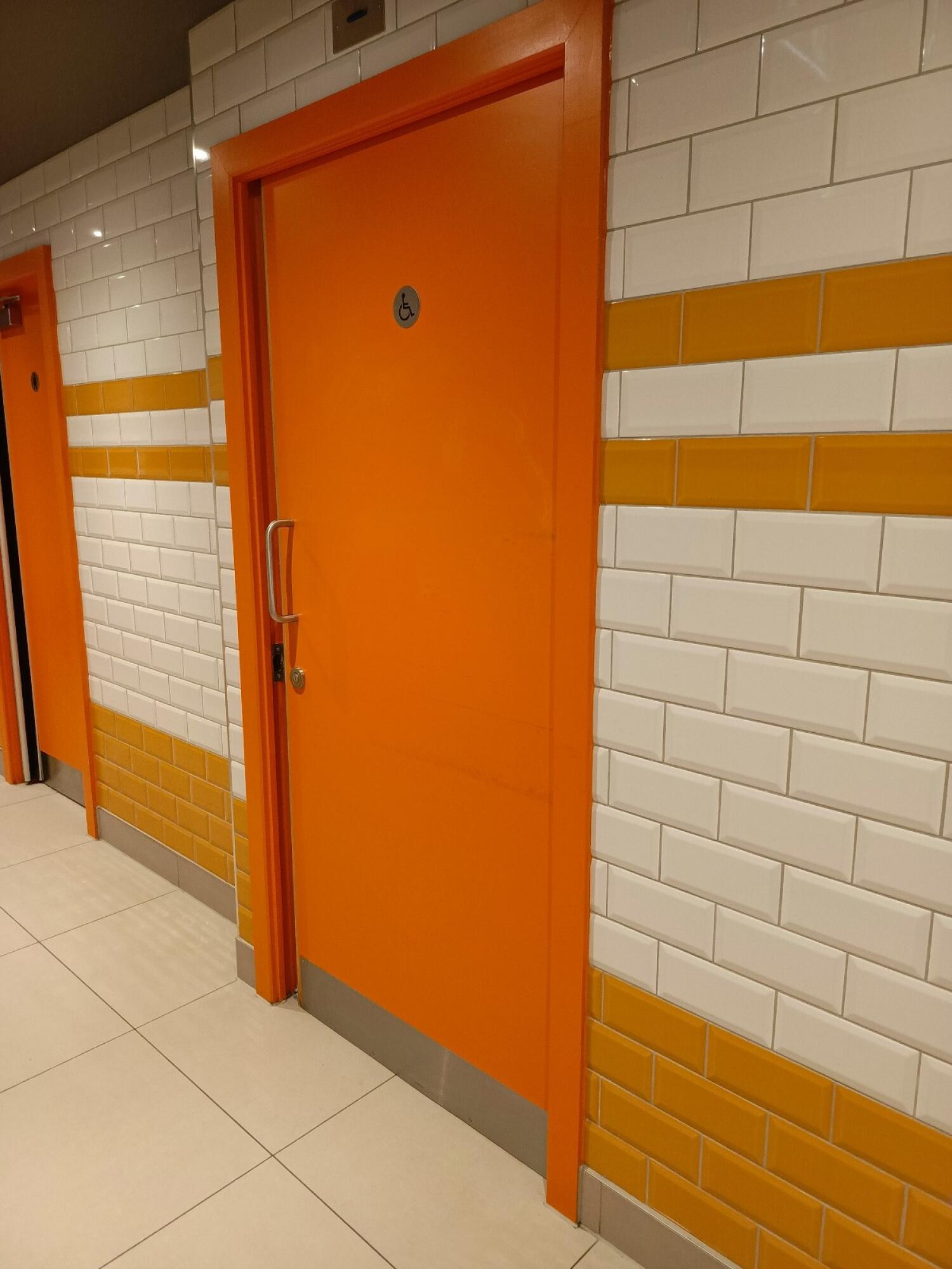 From path to second door on right facing right. Orange door ahead. From handle on left. Slide door to right to open.