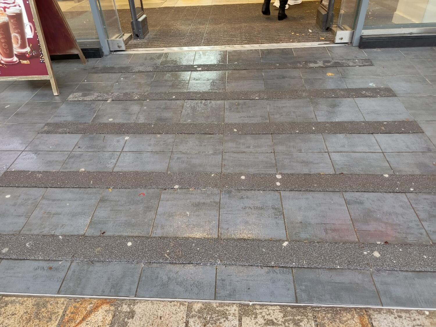 Small slope at foot of entrance.  Doormat following.