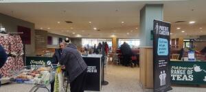 Open archway leading to main area ahead. Promotion desk on left. Path to main area ahead.