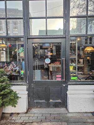Black framed half glass panel door ahead. Pull handle on right to open.