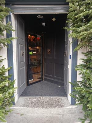 Grey wooden doors ahead. Push from handles at centre to open.