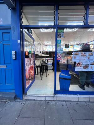 Blue framed glass door ahead. Push handle on right to open.