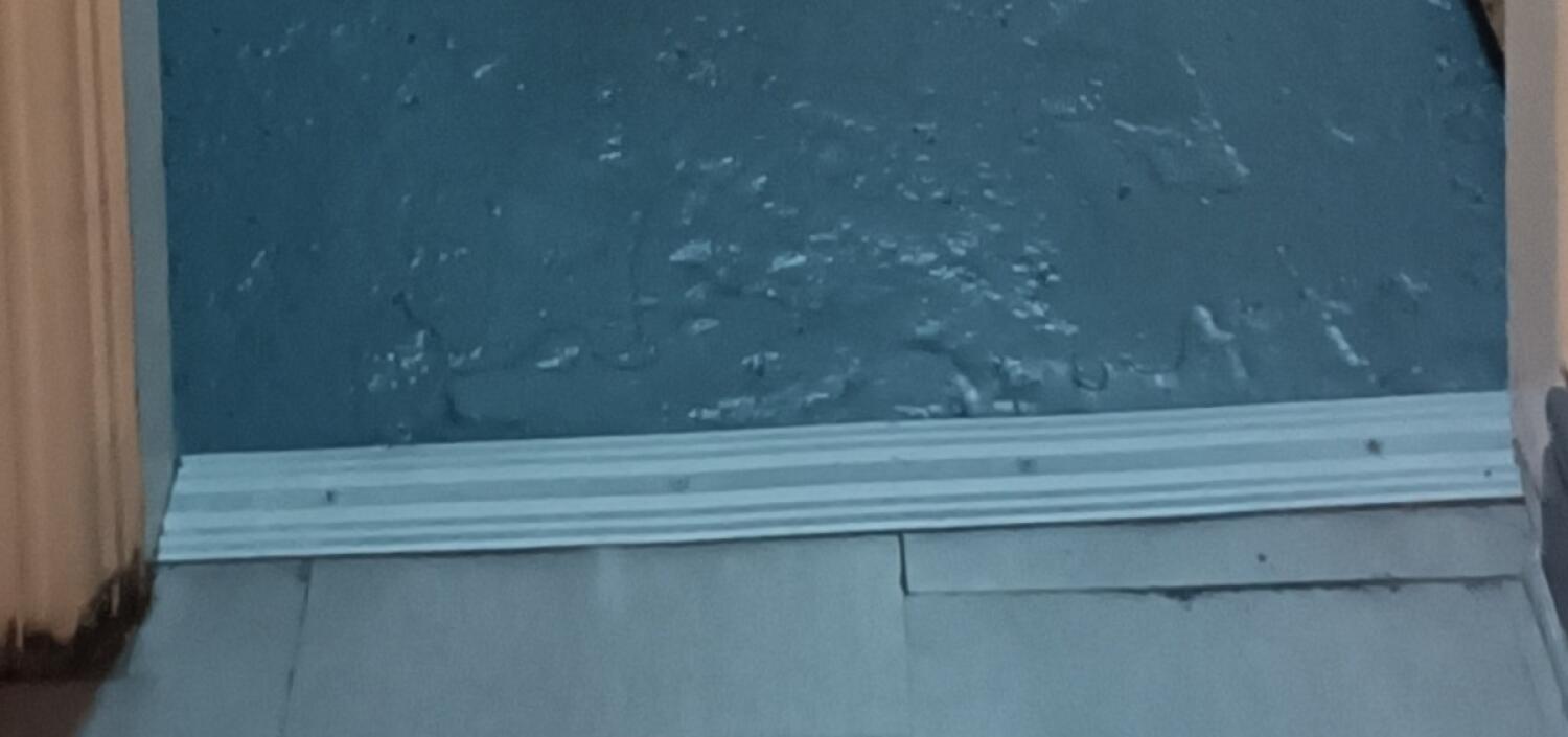Small metal bump at foot of archway.