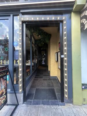 From sidewalk facing venue. Archway ahead.