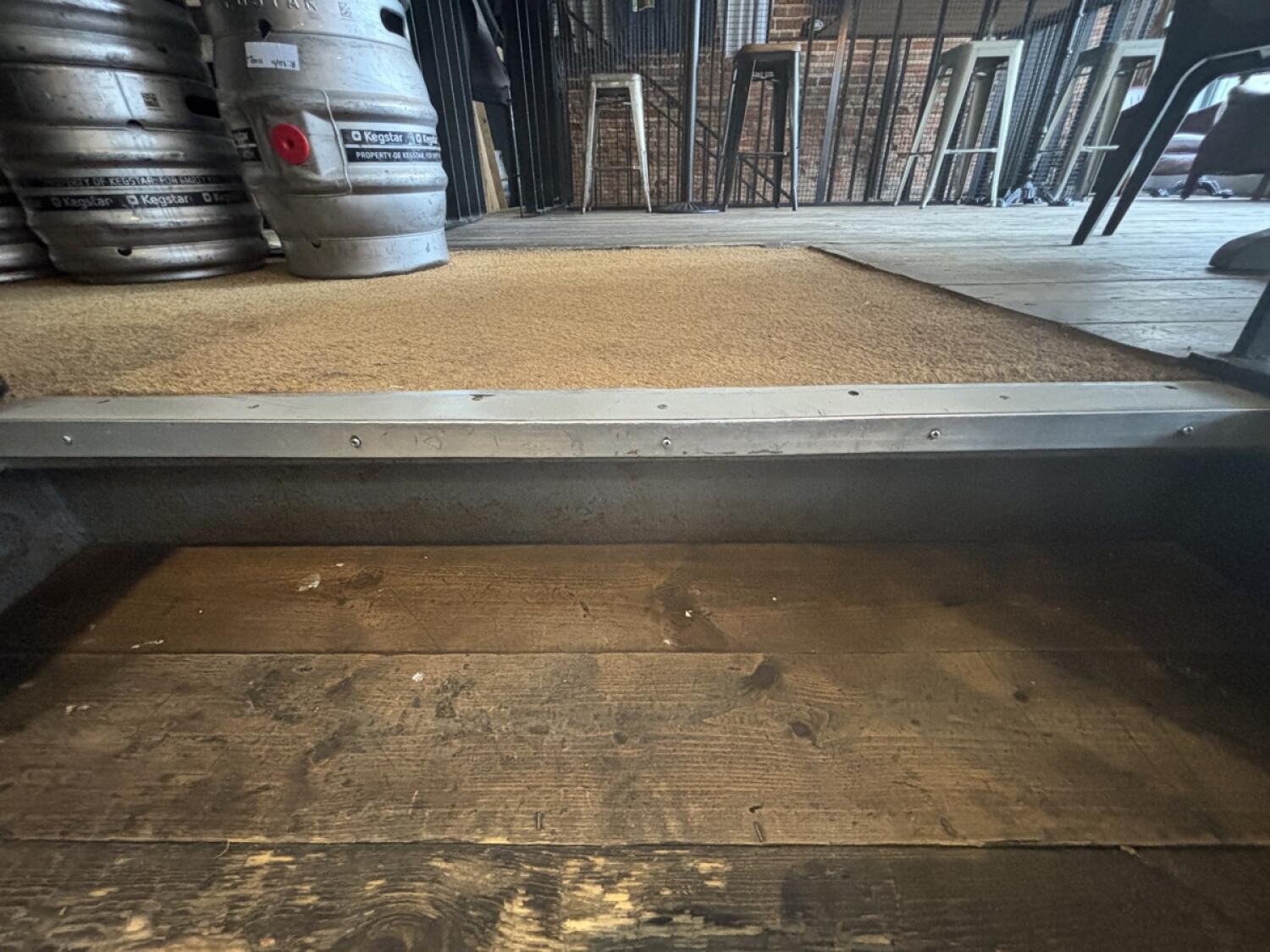One step up to access area. Doormat following step.
