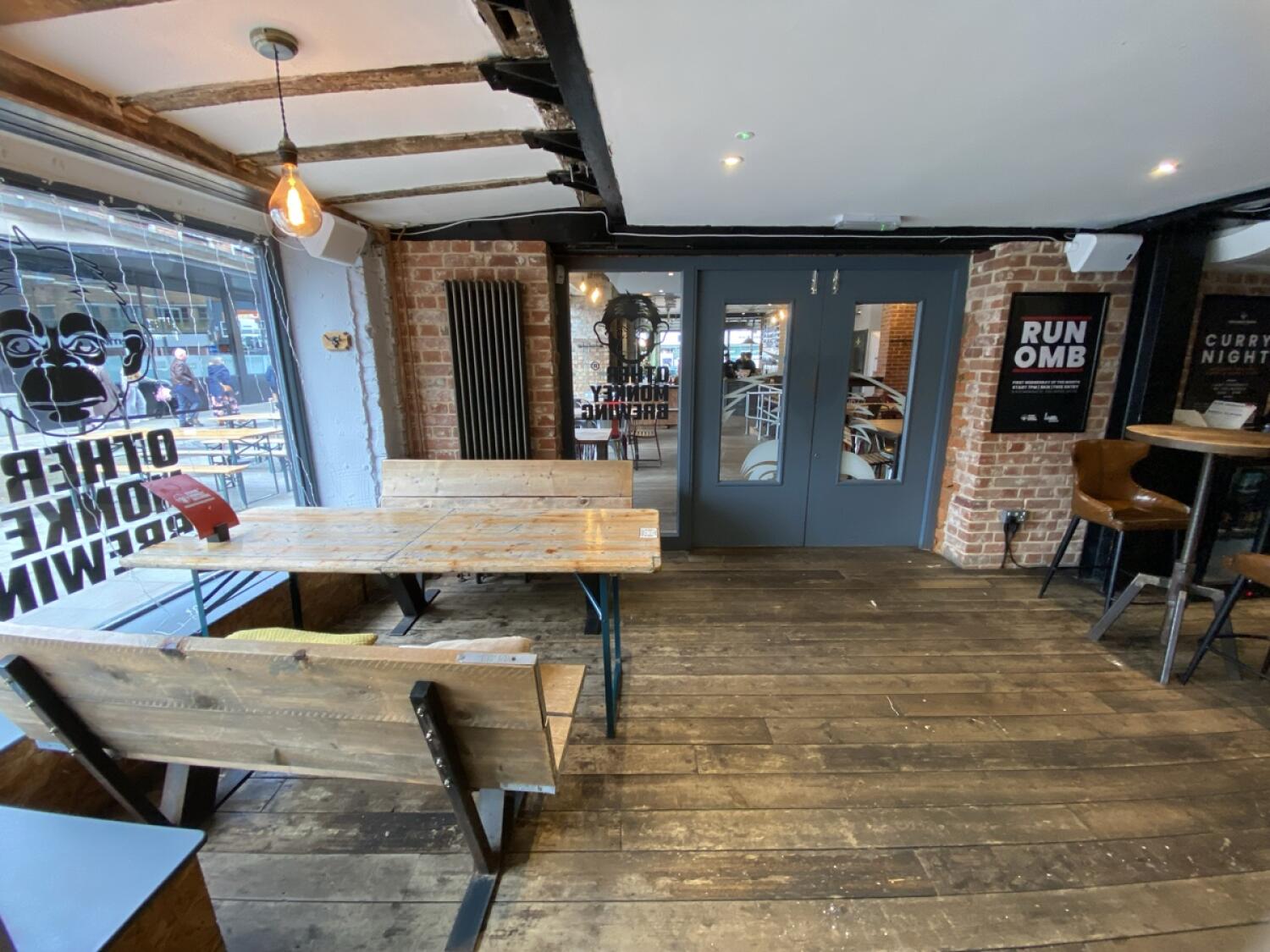 From entrance facing left. Half booths and table on left. Door to Three Wise Monkeys at back.