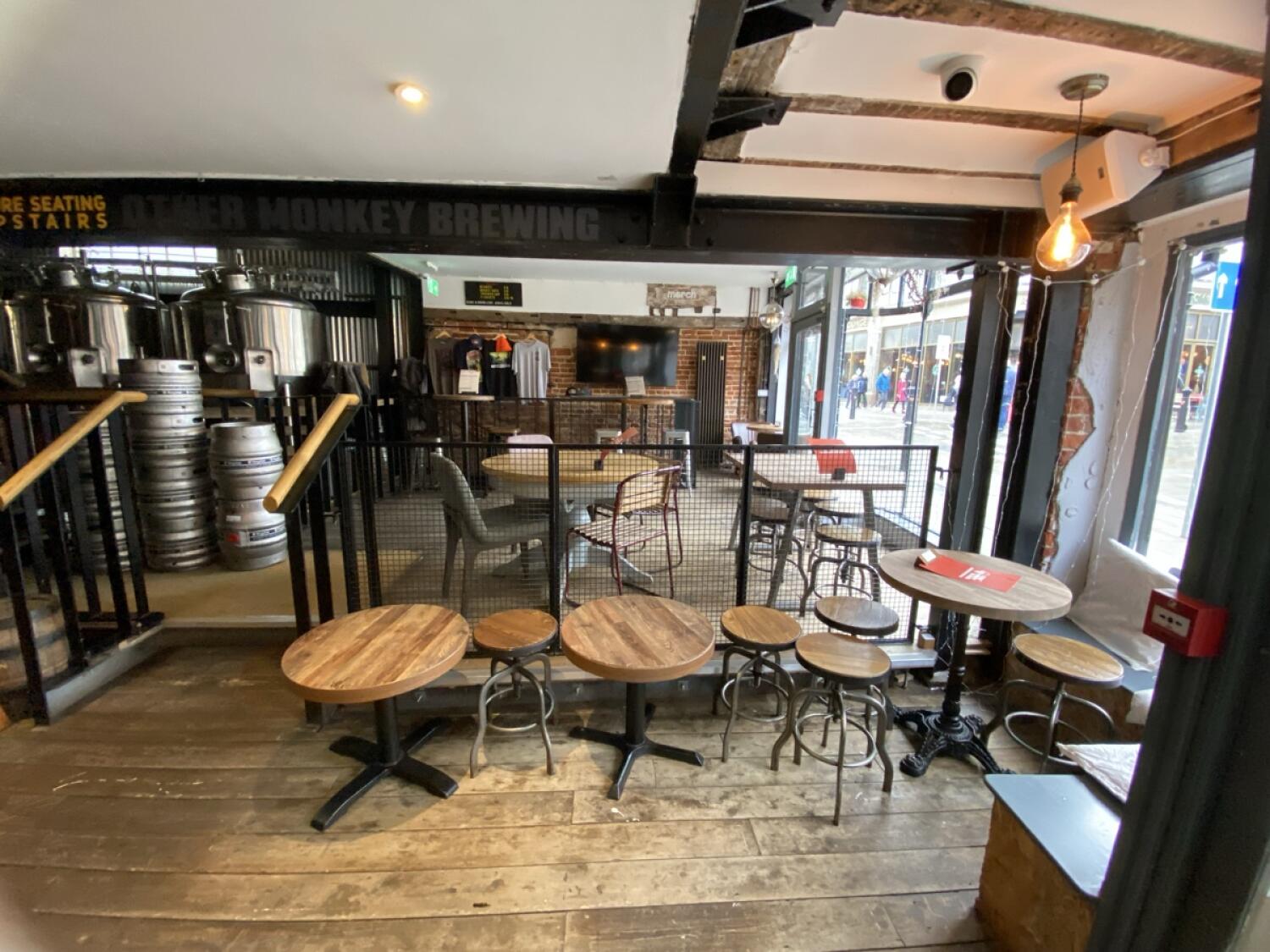 From entrance facing right. Steps to back space at back left. Tables and stools ahead.
