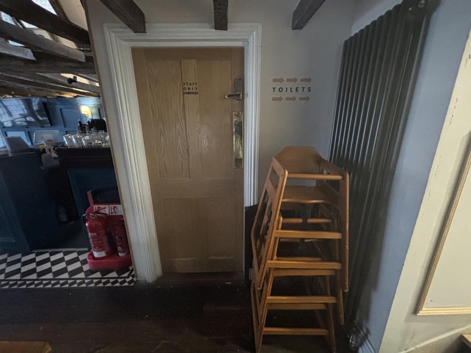From top of staircase facing straight. Baby high chairs on right.