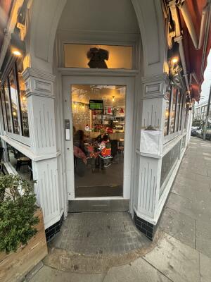 White framed glass door ahead. Push from left to open.