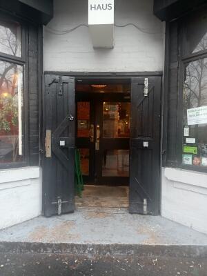 Black wooden doors ahead. Pull from handle at centre to open.