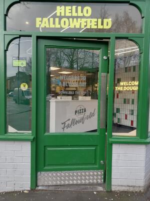 Glass door with green frame ahead. Push from right to open.