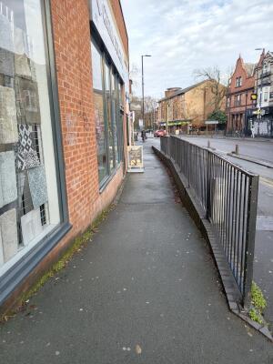 From street facing venue. Path ahead. Fencing on right.