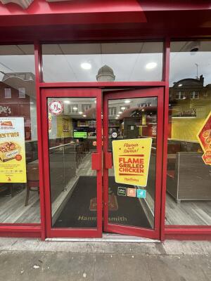 Red framed glass doors ahead. Push from centre to open.