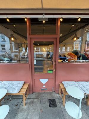 Glass door with red frame ahead. Push from right to open.