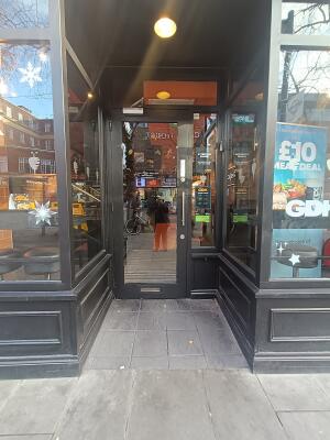 From street, facing venue. Opening ahead.