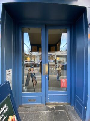 Blue framed glass door. Push from centre to open.