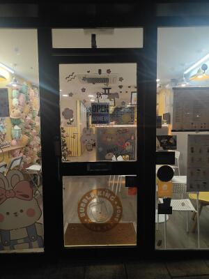 Black framed glass door ahead. Push silver handle on left to open.