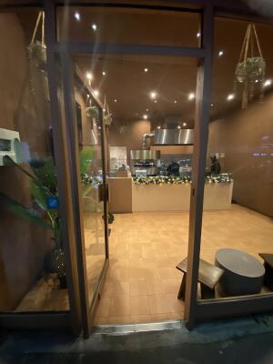 Pink framed glass door. Push from right to open.